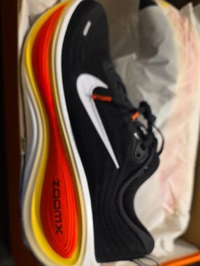 Nike Black Running Shoe with White Swoosh and Red-Orange-Yellow Gradient Midsole